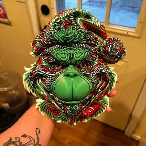 3D printed color layered Grinch wall hanger.